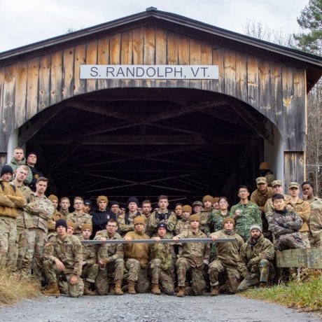 Group of Norwich University Corps of Cadets posing in front of the S. Randolph, VT covered bridge.
