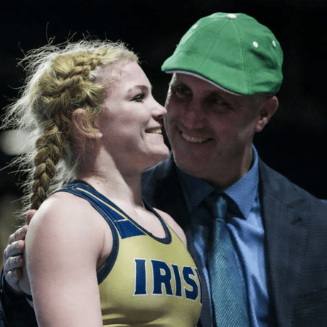 A wrestler and her coach celebrate during an event.