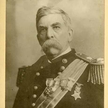 A service member in a decorated military uniform poses for a historical portrait.