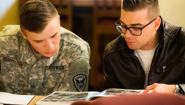 Cadet and civilian student reviewing photo book