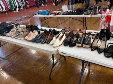 A row of women's dress shoes are presented on several folding tables. These are items donated by Norwich alumni for Dressing for Success, held Feb. 9-10 at Norwich University.
