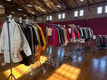 An assortment of women's formal clothing is shown on three separate moveable clothes racks. These are all articles of clothing donated by Norwich alumni for Dressing for Success, held Feb. 9-10 at Norwich University.