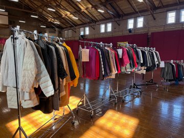 An assortment of women's formal clothing is shown on three separate moveable clothes racks. These are all articles of clothing donated by Norwich alumni for Dressing for Success, held Feb. 9-10 at Norwich University.